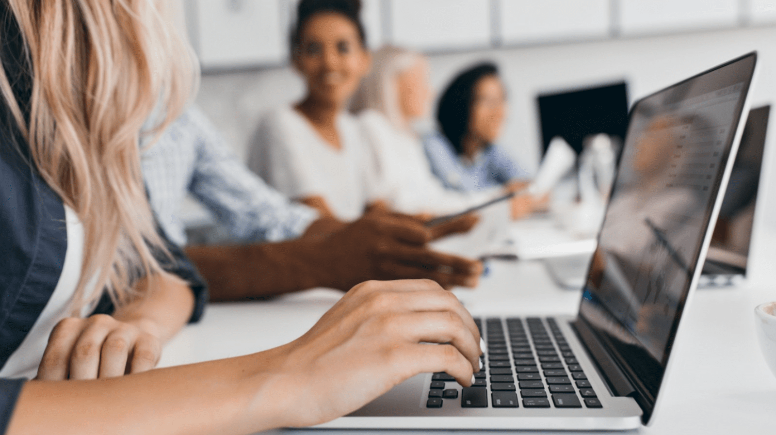 blonde-woman-with-elegant-hairstyle-typing-text-keyboard-office-indoor-portrait-international-employees-with-secretary-using-laptop