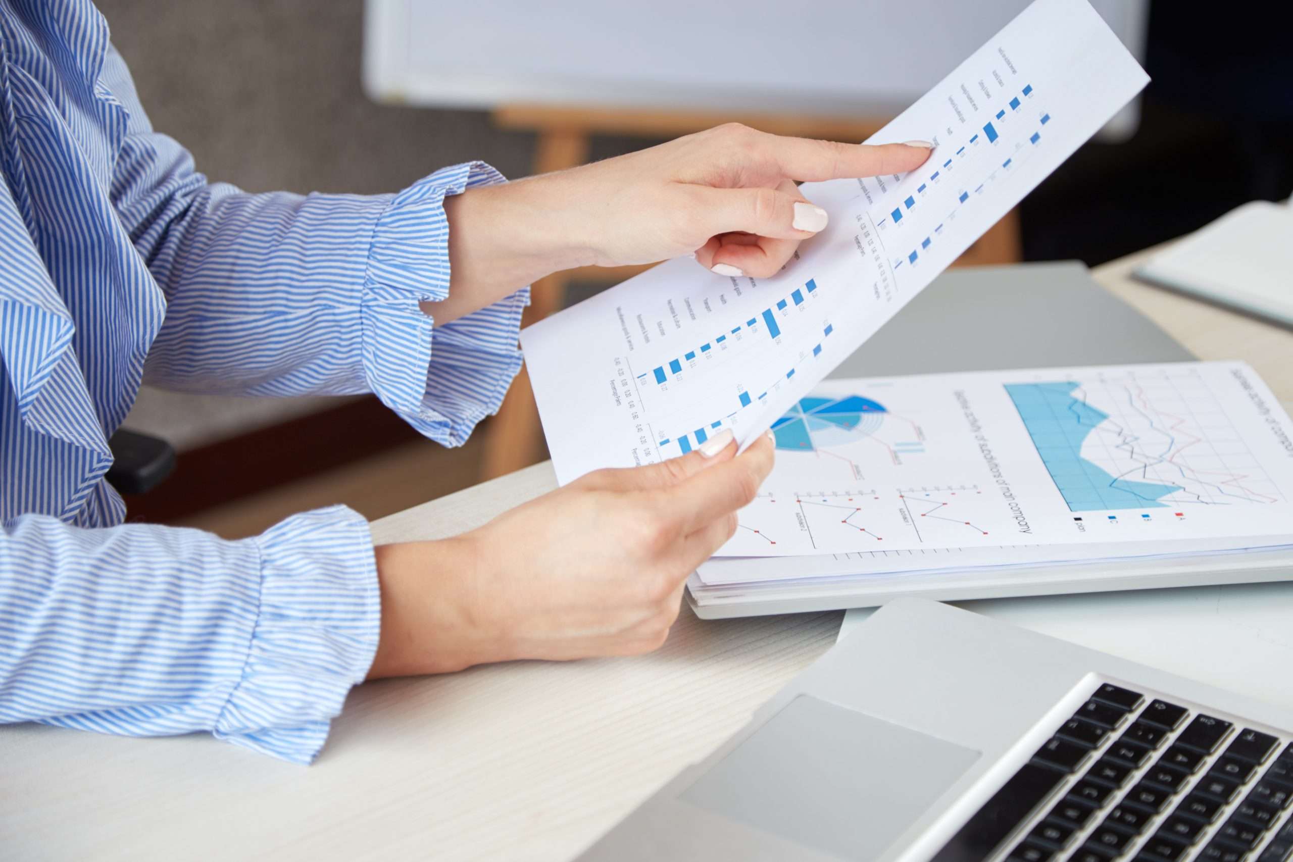 closeup-anonymous-woman-holding-sheet-paper-pointing-diagrams-it